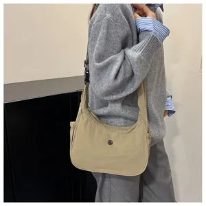 Detail view of casual nylon crossbody underarm shoulder bag in khaki color showing daily style.