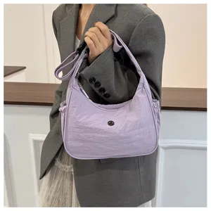 Detail view of a light purple nylon hobo shoulder bag with casual street style design.