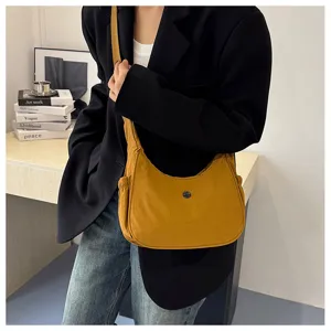 Casual nylon shoulder bag detail shot, lightweight crossbody design for daily wear and street style.