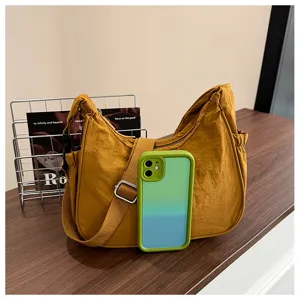 Detailed view of casual nylon shoulder bag with adjustable strap and side pocket design.