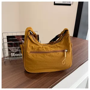 Detailed view of casual nylon hobo shoulder bag with practical front zipper pocket.