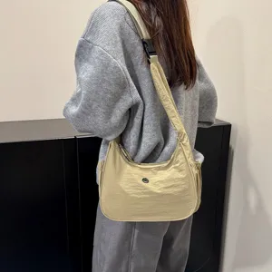 Minimalist nylon shoulder bag for women, casual crescent crossbody bag, daily lightweight style.