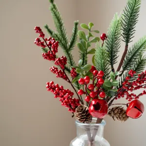Artificial Christmas floral branch detail featuring pine needles, red berries, and pine cones.