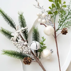 Artificial Christmas pine branches with white berries and pinecones for holiday home decor.