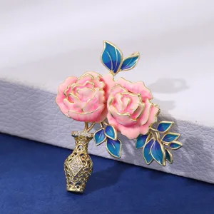 Exquisite enamel peony vase brooch with vibrant pink flowers, blue leaves, and gold plating.