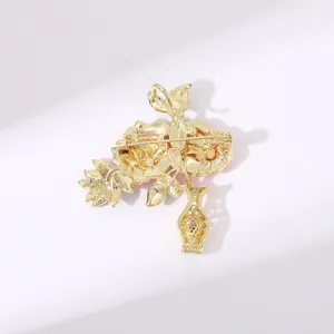 Back view detail of gold plated peony flower vase brooch pin showing sturdy clasp and hinge.