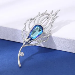 Exquisite feather brooch featuring gradient blue crystal and sparkling cubic zirconia stones.