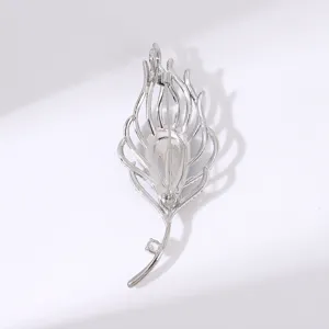 Detail shot of the silver feather brooch back pin mechanism, elegant metal accessories for coat.