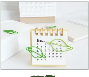 Green leaf-shaped paper clips metal stationery bookmarks for office desk decoration details.