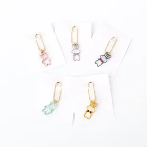 Detailed view of cute cartoon animal metal paper clips with bowties on white cards.