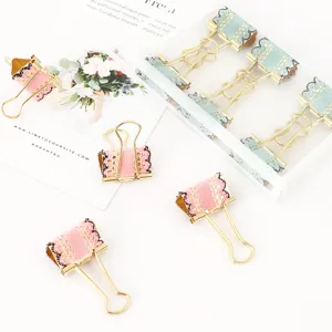 Cute colorful metal binder clips with lace decor, perfect stationery for office and school use.