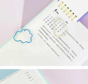 Cute cloud shaped metal paper clips detail, aesthetic stationery for planners and books.