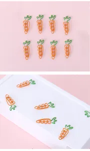 Creative cute carrot shaped metal paper clips, colorful office and school stationery items.