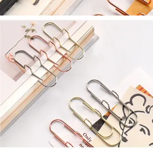 Close up of electroplated metal pen clips and bookmarks, showing fine metallic finish and details.