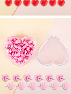 Close-up detail shot of cute pink heart-shaped pushpins with transparent storage box display.