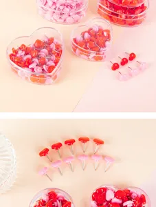 Close-up detail view of cute heart-shaped push pins in transparent storage boxes for cork boards.