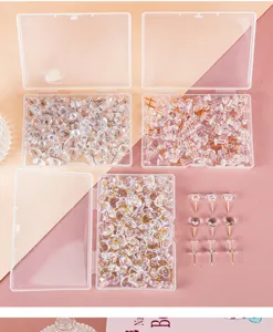 Clear push pins and thumbtacks set in storage box, perfect for cork boards and photo walls.