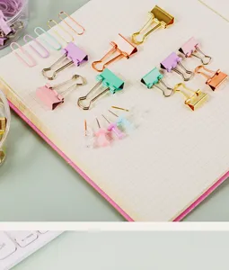 Creative multi-functional office stationery set with colorful binder clips, paper clips and pins.