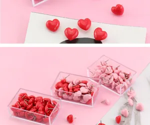 Close-up detail of cute heart-shaped push pins in clear boxes, perfect for corkboards.
