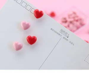 Cute heart-shaped pushpins, colorful plastic thumbtacks for cork boards and memo notes.