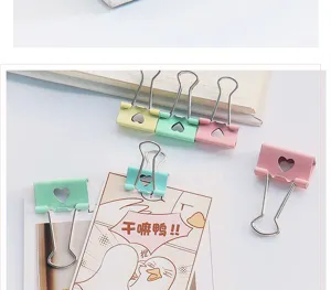 Colorful metal binder clips with cute hollow heart design for office and stationery use.