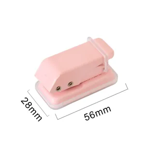 Pink metal mini single hole punch for loose leaf paper binding and student stationery use.