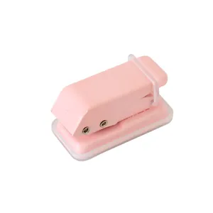 Pink mini metal single hole puncher for paper binding, cute student stationery tool main view.