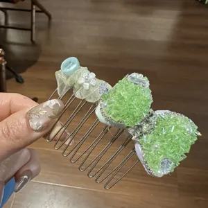 Mint green rhinestone bow hair comb detail view, sparkling crystals and delicate fabric flower.