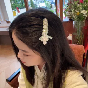 Korean style mint green hair comb with bows, rhinestones and floral details for women.