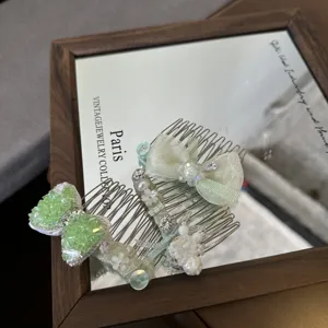 Mint green hair comb detail, featuring bows, rhinestones and delicate floral embellishments.