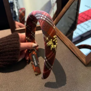 Plaid woolen headband with gold horse charm and H detail, stylish autumn winter hair accessory.
