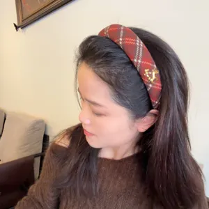 Red plaid woolen headband with gold horse charm, winter hair accessory for women.