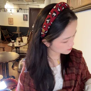 Red leopard print headband, stylish wool hair hoop for autumn winter wear, cozy scene detail.