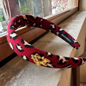 Red leopard print headband with golden horse charm, stylish fleece hair hoop for women and girls.