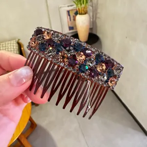 Close-up detail of sparkling rhinestone hair comb with colorful crystals for elegant hairstyles.
