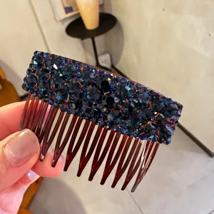 Detail view of a sparkling dark blue rhinestone insert comb, beautiful crystal hair accessory.