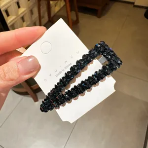 Λεπτομέρεια από μαύρο κλιπ μαλλιών με κρυστάλλινα στρας και αστραφτερές κομμένες πέτρες.