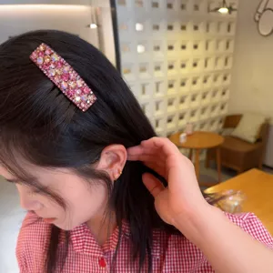 Sparkling rhinestone hair clip detail shot, elegant pink crystal barrette for women and girls.