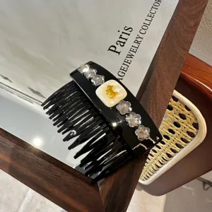 Elegant black hair comb with sparkling crystals and cute golden bear accent for women.
