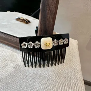 Rhinestone hair comb detail showing sparkling crystal stars and cute golden dog charm accent.