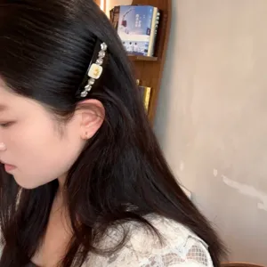 Detailed shot of Korean style rhinestone hair comb, elegant black resin insert comb for women.