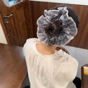 Stylish denim scrunchie with lace trim, perfect for casual ponytails and buns hair styling.