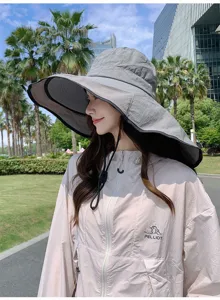Detailed view of the outdoor sun protection hat and lightweight jacket in a scenic park.