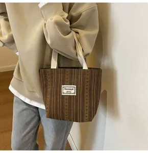 Japanese striped canvas tote bag detail view, casual shoulder handbag for daily commute.