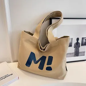 Khaki canvas tote bag with blue M print, casual large capacity single shoulder shopping bag.