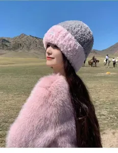 Cute winter plush color-block warm hat and fluffy sweater detail, cozy outdoor style.