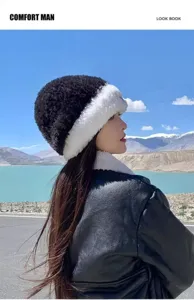 Detailed view of the plush warm winter hat in black and white, cozy and stylish outdoor look.