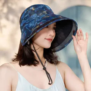 Close-up of stylish blue printed sun protection hat with wide brim for outdoor summer.