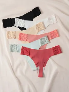 Low-waist seamless lace thong for women, breathable ice silk fabric with cotton crotch.