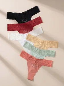 Close-up detail of sexy lace thong with rhinestone love embellishment and multi-color options.